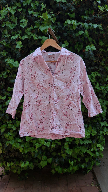 Floral-patterned shirt on a green leafy background