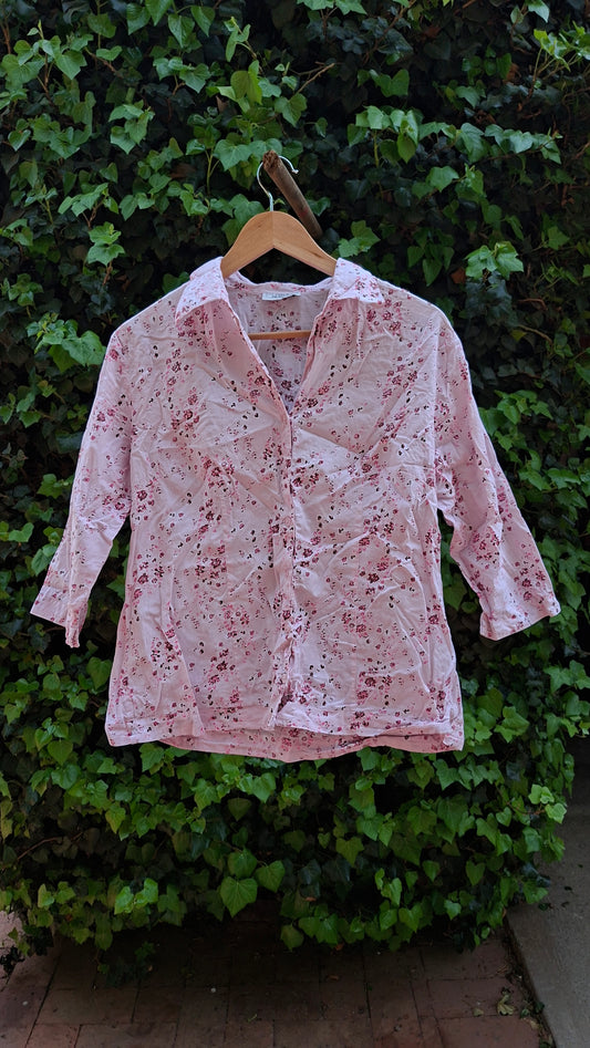 Floral-patterned shirt on a green leafy background