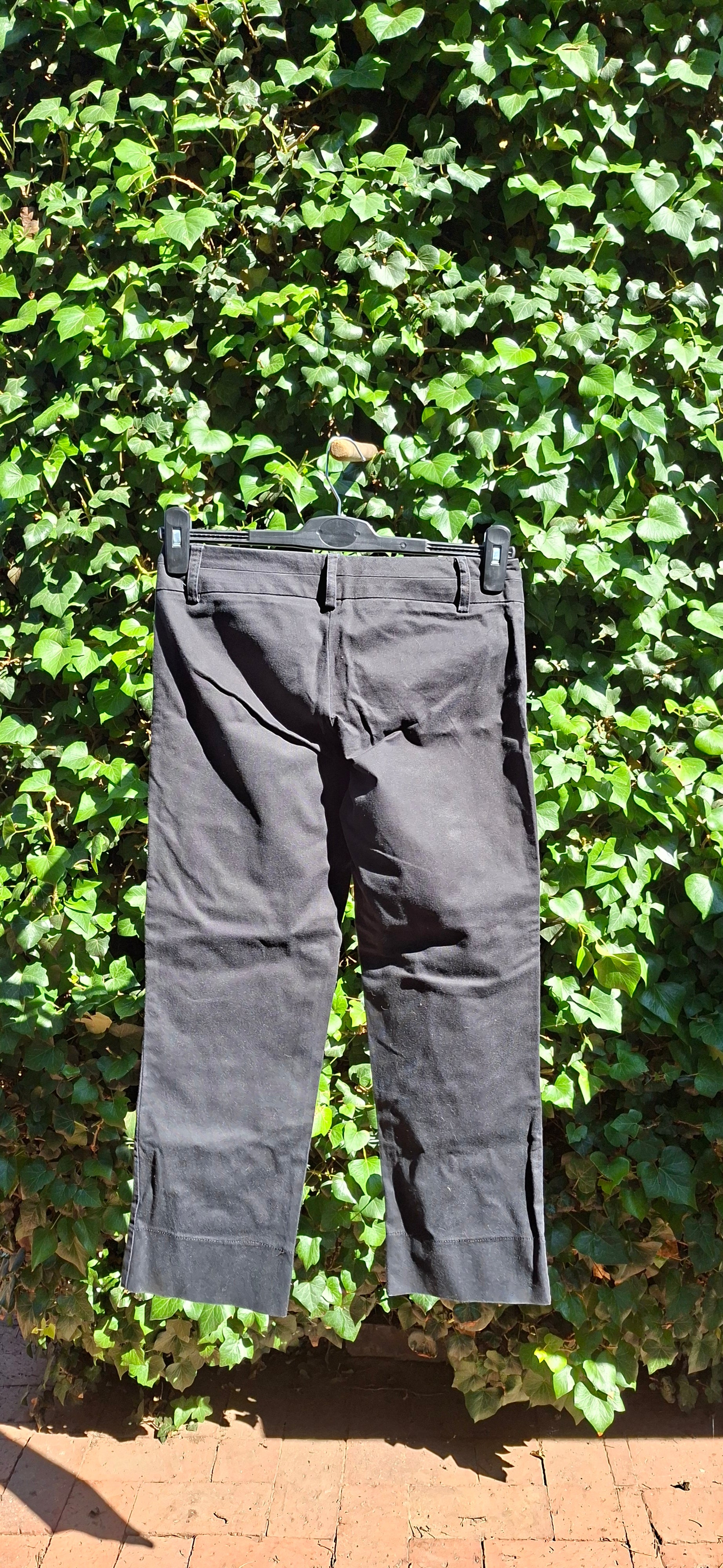 Black pants on a green leafy background